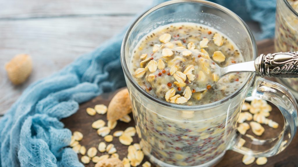 Glass of soaked oats and quinoa with coconut milk