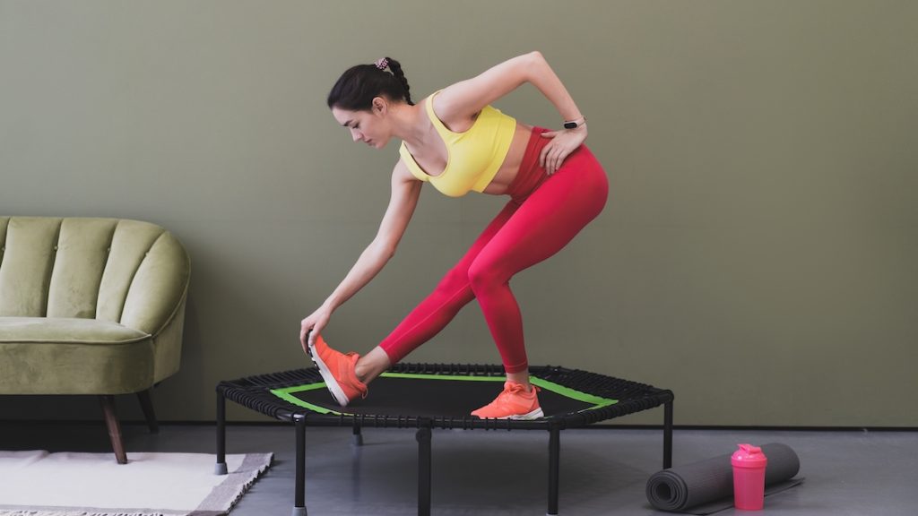 Woman doing a stretching exercise on a rebounder