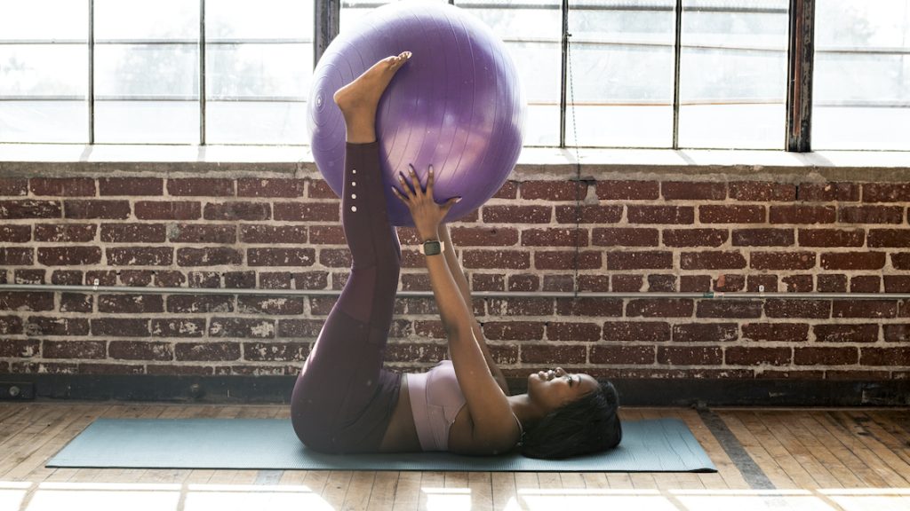 Woman using a stability ball during an exercise at home