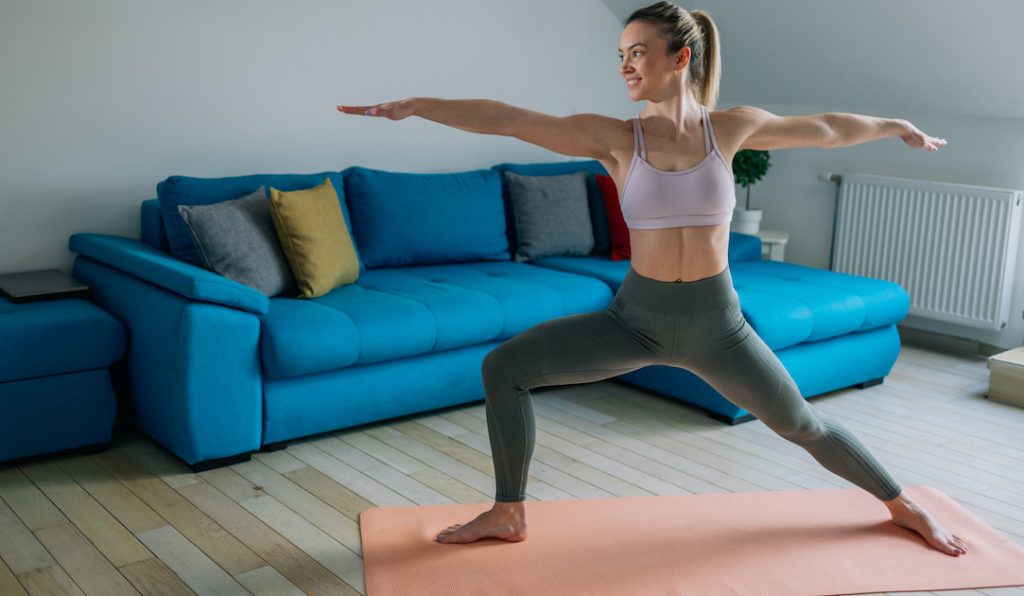 Woman doing a yoga pose on a yoga mat