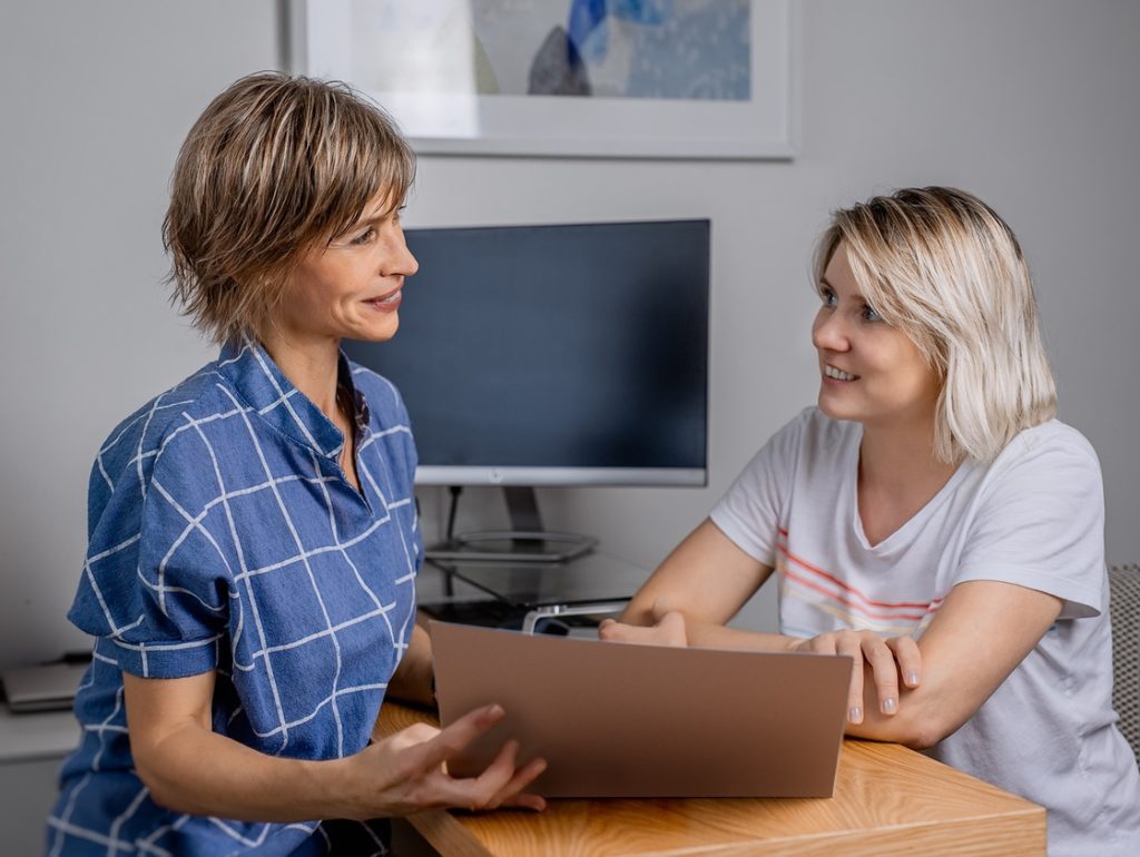 Woman talking to doctor before starting beginners exercise routine