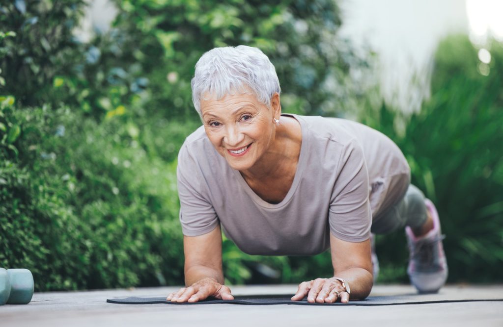 Mature woman holding plank as part of beginner weekly exercise routine