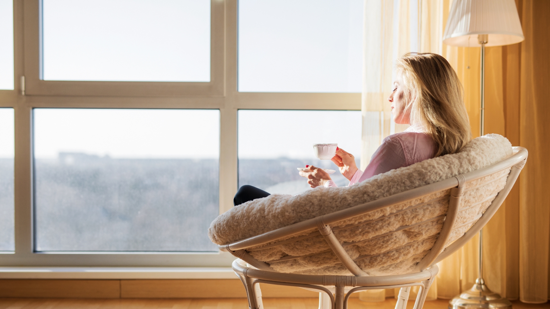 woman calmly thinking by window