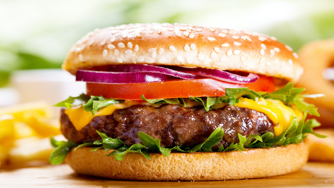 hamburger with fries on wooden table