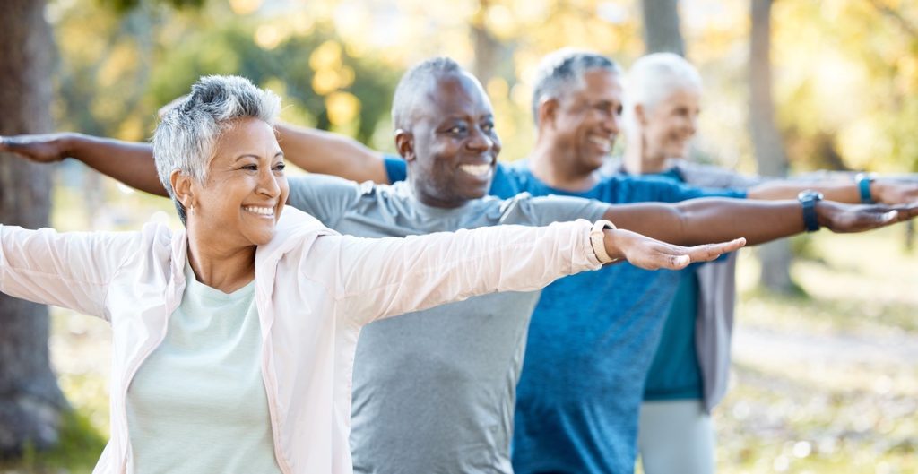 Group of individuals working out in a park outside