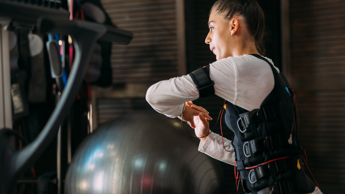 Woman working out with weighted vest on 